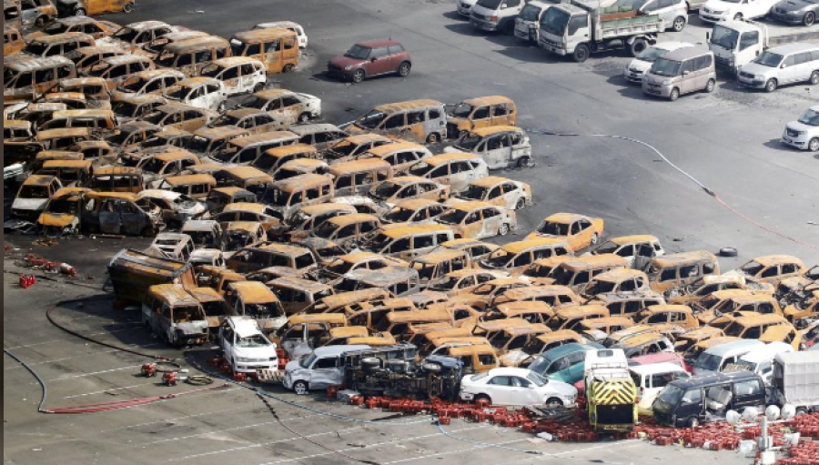 Typhoon kills 10 in Japan, boats move stranded passengers from airport