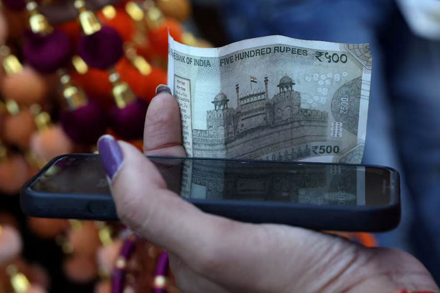 Rupee cracks below 90 to the dollar, hit by tariffs, capital outflows