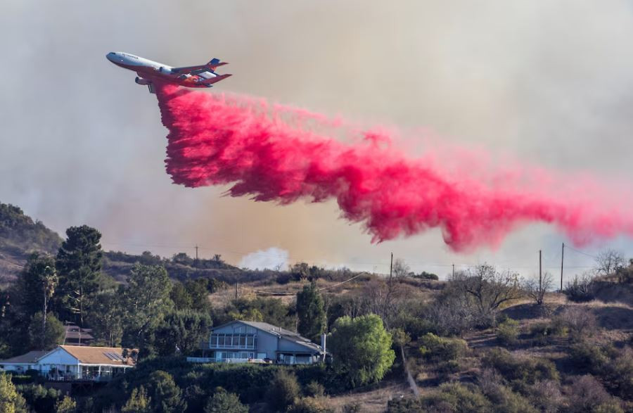 Aerial assault aims to stem LA Palisades fire eastward spread
