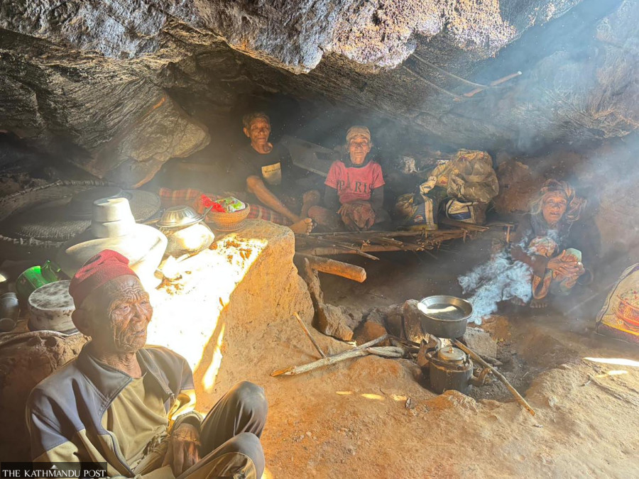 Two generations in a makeshift home under a boulder
