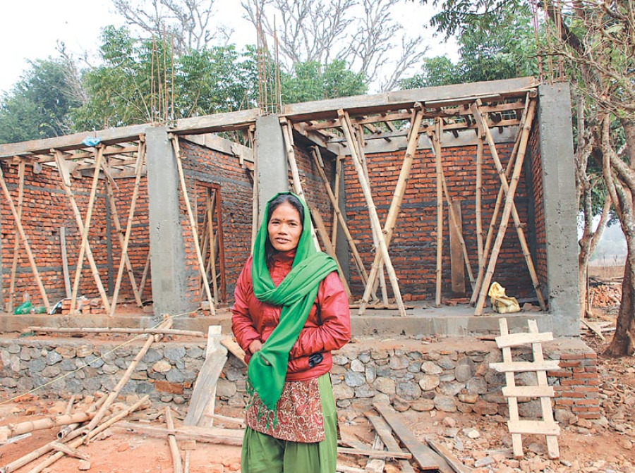 Female contractor busy building quake-hit village