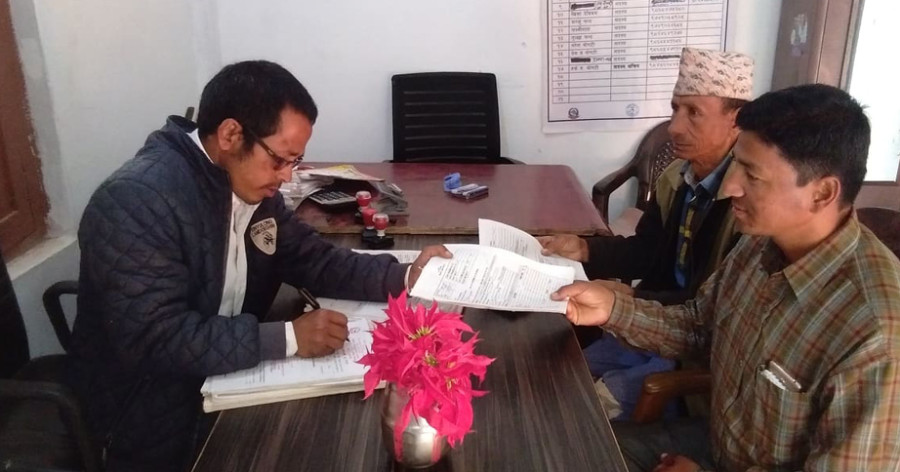 Health workers carry out administrative tasks in Bogtan, Doti