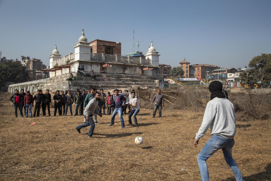 Students play football in quake-ravaged Rani Pokhari