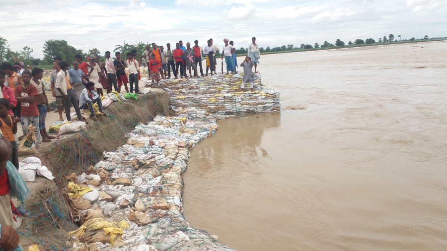 Embankments destroyed in floods in Province 2 are being filled with sandbags that are not strong enough to contain water