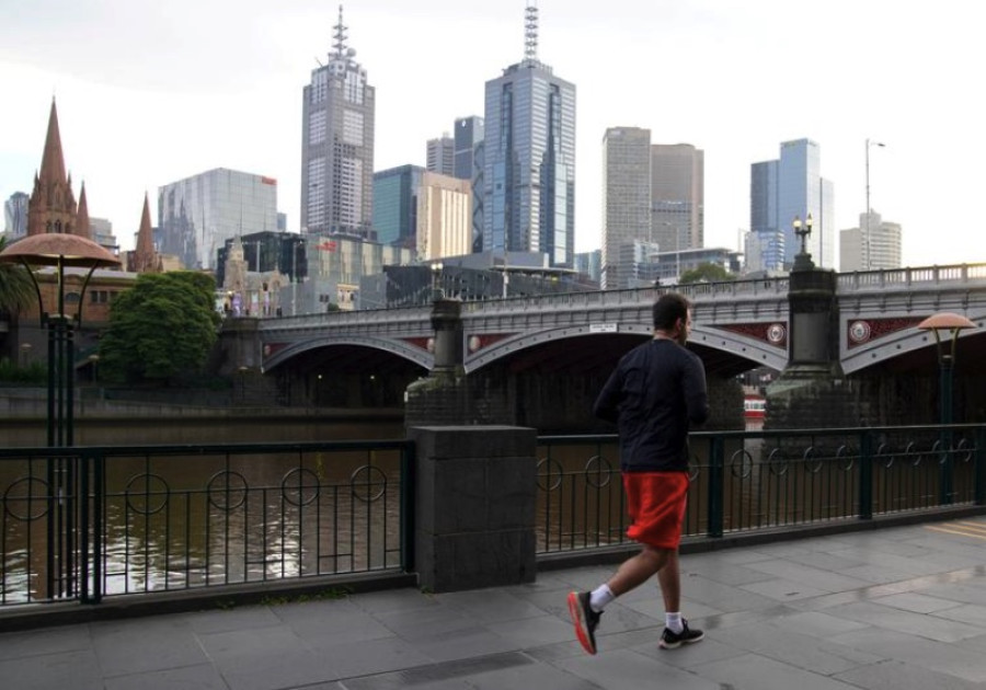 Australia's COVID-19 hotspot sees more school cases before easing curbs