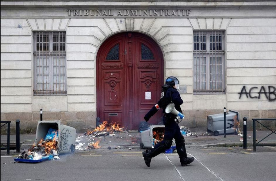 Embattled Macron heads to China, leaving burning Paris behind